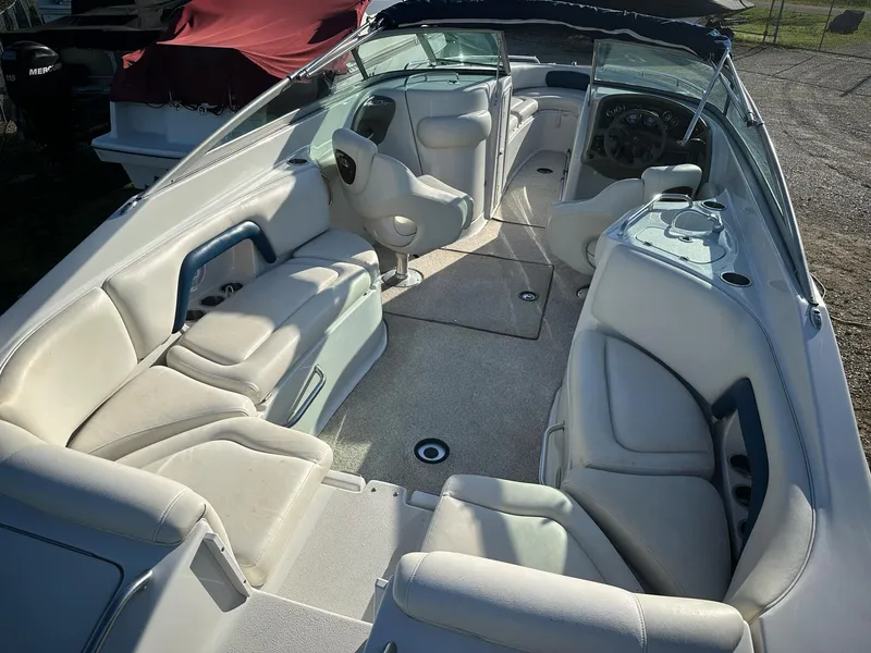 Slide: The Image of 2006 Crownline 270 BR boat interior with white seating and steering console. - 18