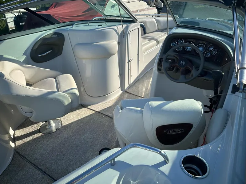 Slide: The Image of 2006 Crownline 270 BR boat interior with steering wheel and seating area. - 19