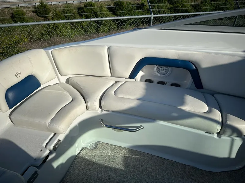 Slide: The Image of 2006 Crownline 270 BR boat interior with white and blue cushioned seating. - 20