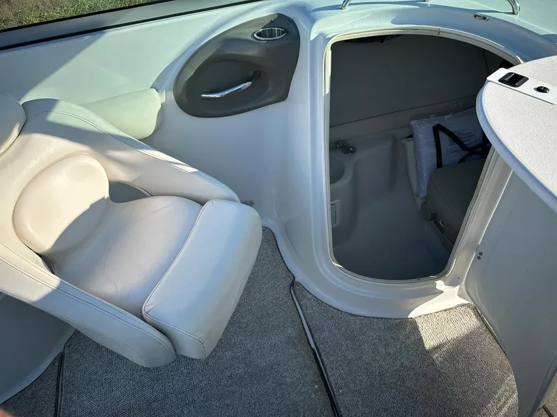 Slide: The Image of 2006 Crownline 270 BR boat interior with seating and cabin entrance. - 21