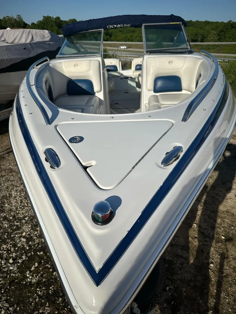 Slide: The Image of 2006 Crownline 270 BR boat with blue accents, docked outdoors. - 22
