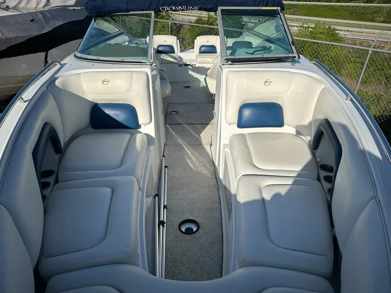 Slide: The Image of 2006 Crownline 270 BR boat interior with white and blue seating, open deck layout. - 3