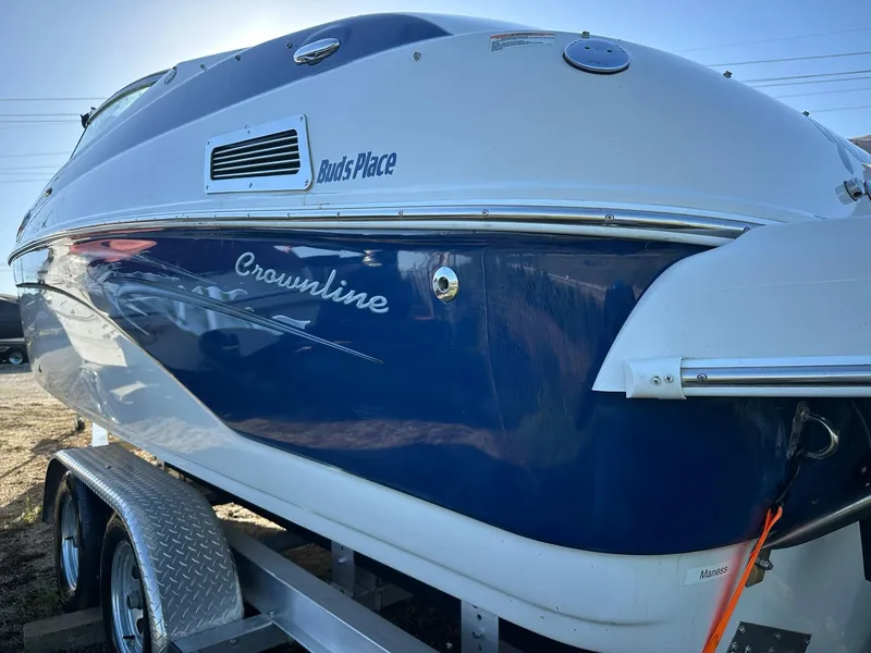 Slide: The Image of 2006 Crownline 270 BR boat on trailer, blue and white exterior. - 4