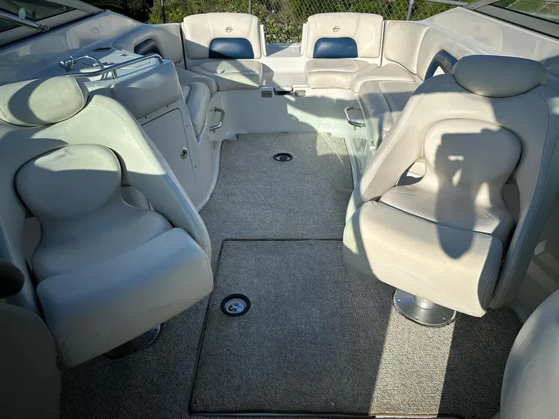 Slide: The Image of 2006 Crownline 270 BR boat interior with plush seating and carpeted flooring. - 5