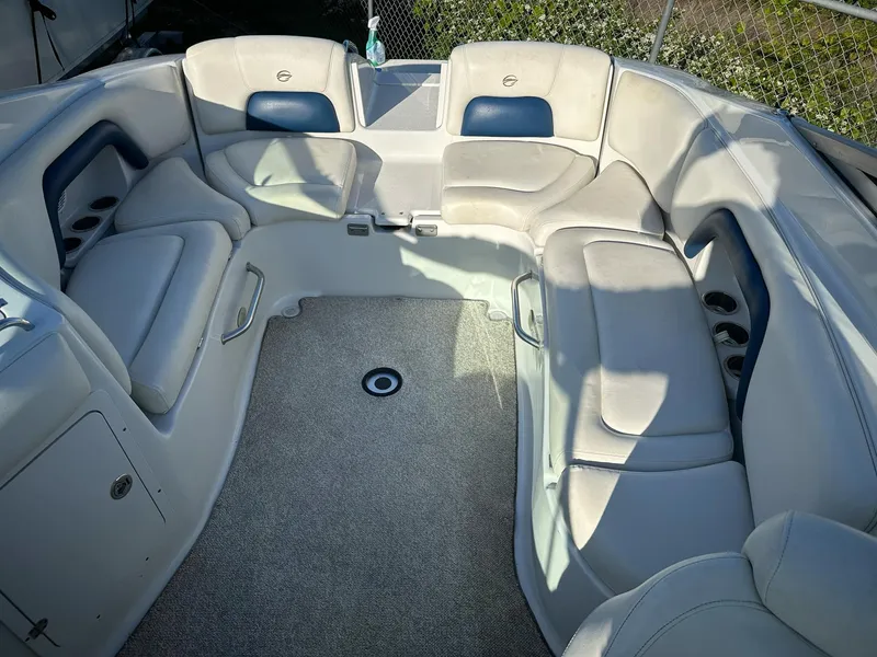 Slide: The Image of 2006 Crownline 270 BR boat interior with spacious seating and carpeted flooring. - 7