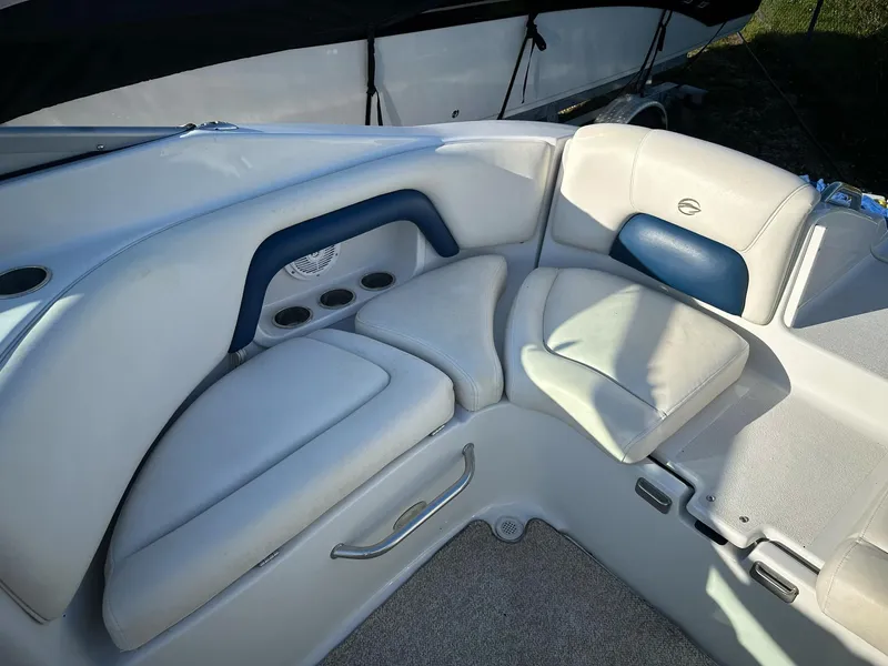 Slide: The Image of 2006 Crownline 270 BR boat interior with cushioned seating and cup holders. - 8