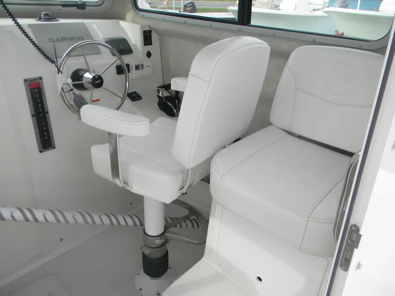 Slide: The Image of 2025 Parker 2820 XLD Sport Cabin interior with white captain's chairs and steering wheel. - 4