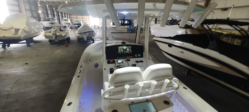 Slide: The Image of 2023 Regulator 26XO boat in indoor storage with other vessels. - 11