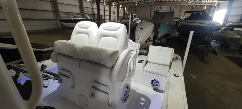 Slide: The Image of 2023 Regulator 26XO boat interior with white seating in a storage facility. - 13