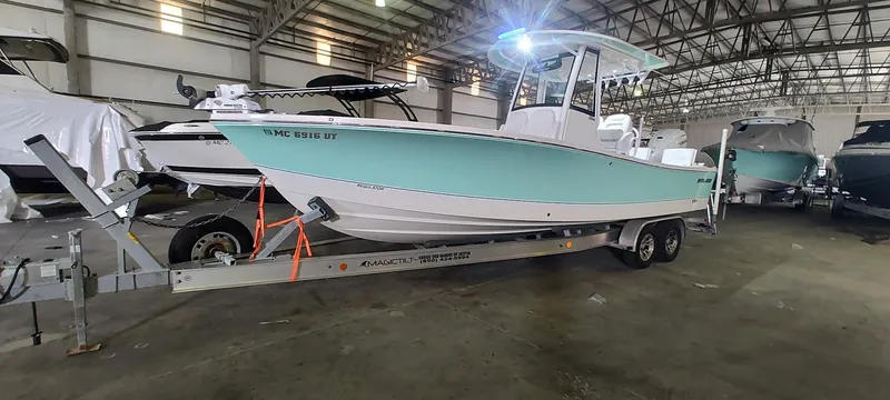 Slide: The Image of 2023 Regulator 26XO boat on trailer in indoor storage facility. - 3