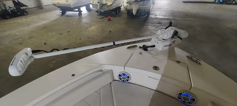 Slide: The Image of 2023 Regulator 26XO boat with trolling motor in a garage setting. - 34
