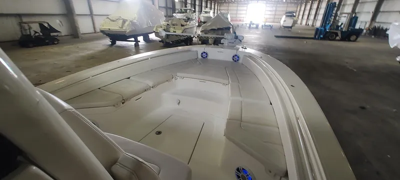 Slide: The Image of 2023 Regulator 26XO boat in storage, showcasing spacious deck and sleek design. - 36