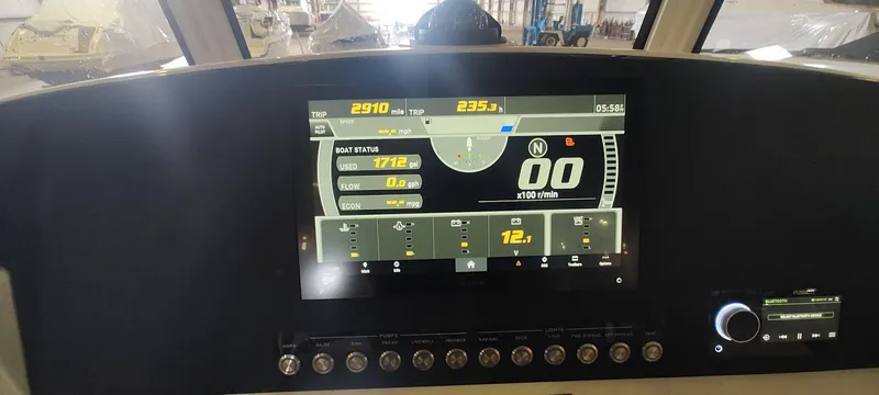 Slide: The Image of 2023 Regulator 26XO dashboard with digital display and control panel. - 37