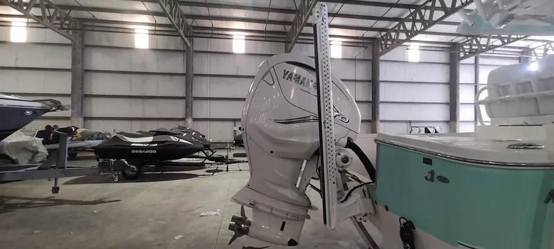 Slide: The Image of 2023 Regulator 26XO boat with Yamaha outboard in a storage facility. - 39