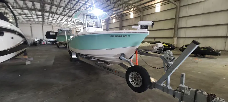 Slide: The Image of 2023 Regulator 26XO boat on trailer in warehouse setting. - 5