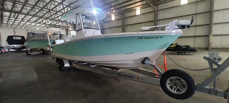 Slide: The Image of 2023 Regulator 26XO boat on trailer in indoor storage facility. - 6