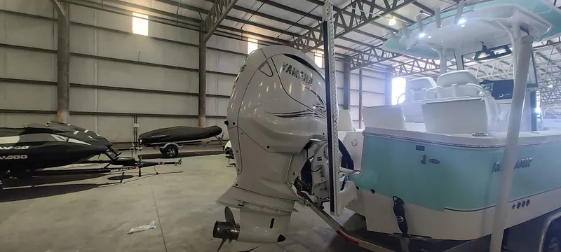 Slide: The Image of 2023 Regulator 26XO boat in warehouse with Yamaha outboard motor. - 8
