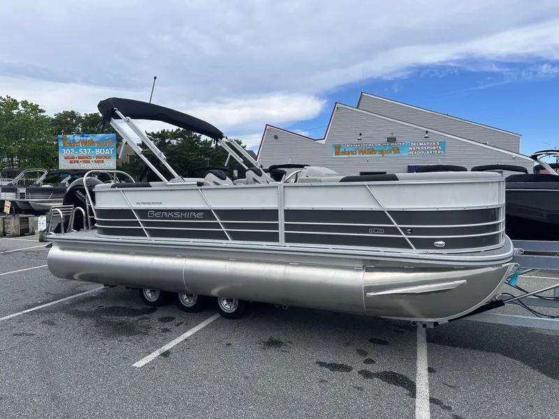 The Image of 2025 Berkshire 22RFX LE 2.75 pontoon boat parked in a lot under a blue sky. - 1