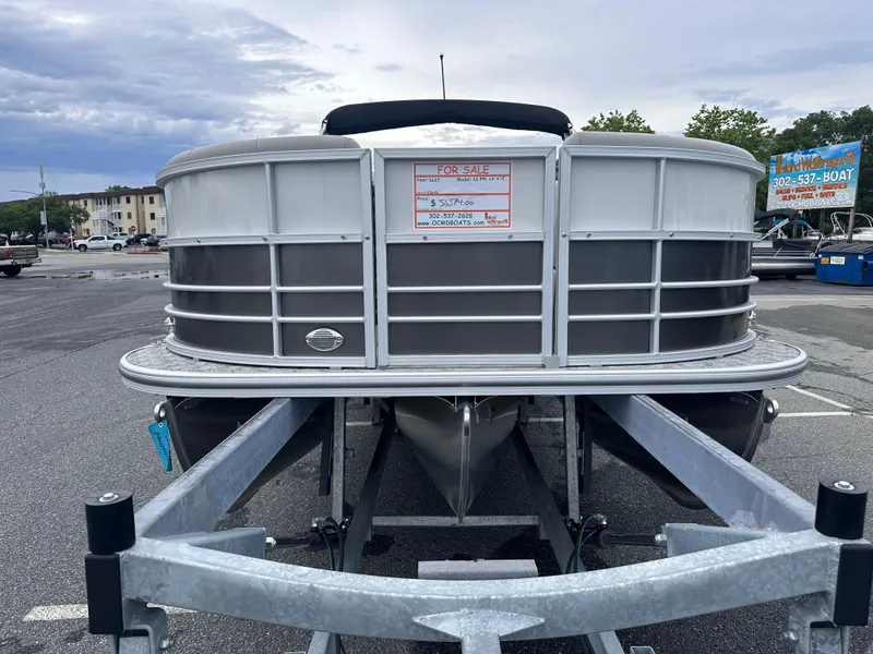 Slide: The Image of 2025 Berkshire 22RFX LE 2.75 pontoon boat on trailer in parking lot. - 3
