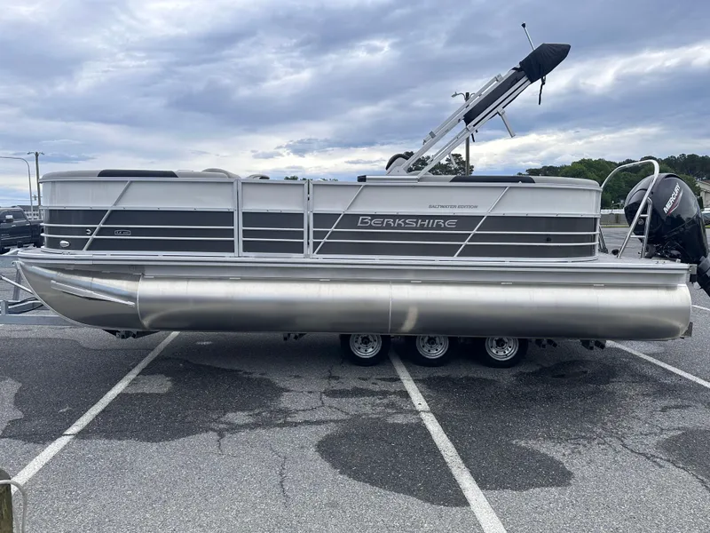 Slide: The Image of 2025 Berkshire 22RFX LE 2.75 pontoon boat parked on asphalt under cloudy sky. - 5