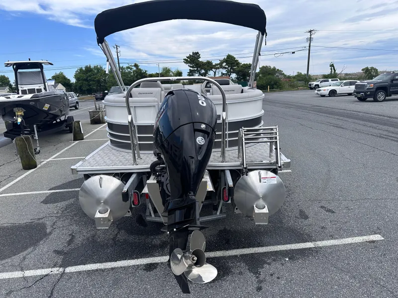 Slide: The Image of 2025 Berkshire 22RFX LE 2.75 pontoon boat with outboard motor in parking lot. - 6