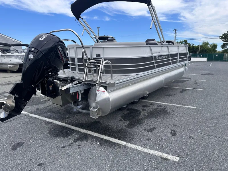 Slide: The Image of 2025 Berkshire 22RFX LE 2.75 pontoon boat with outboard motor in parking lot. - 7