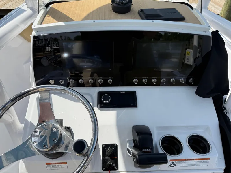 Slide: The Image of 2023 Sportsman Open 232 Center Console dashboard with steering wheel and controls. - 11