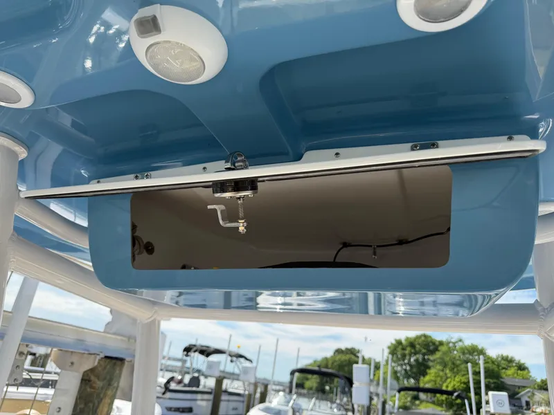 Slide: The Image of 2023 Sportsman Open 232 Center Console boat with open storage compartment and speakers. - 12