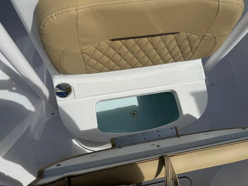Slide: The Image of 2023 Sportsman Open 232 Center Console boat seat and storage compartment. - 14
