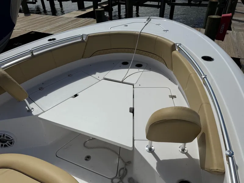 Slide: The Image of 2023 Sportsman Open 232 Center Console boat with tan seating and white deck. - 15
