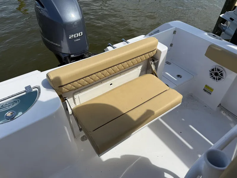 Slide: The Image of 2023 Sportsman Open 232 Center Console boat with tan seating and Yamaha 200 engine. - 5