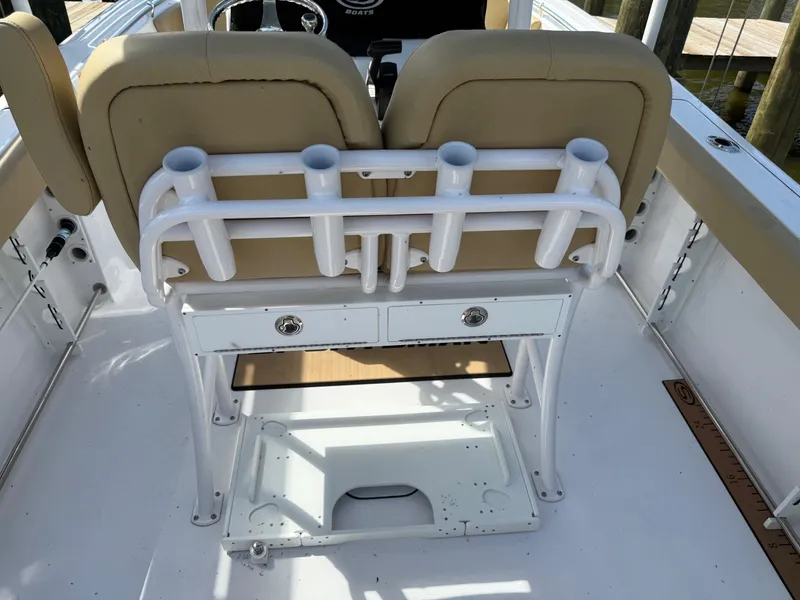 Slide: The Image of 2023 Sportsman Open 232 Center Console boat interior with rod holders and seating. - 8