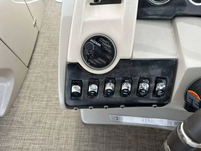 Slide: The Image of Control panel of a 2016 Bennington 2875 QCW I/O boat with switches and ignition. - 10
