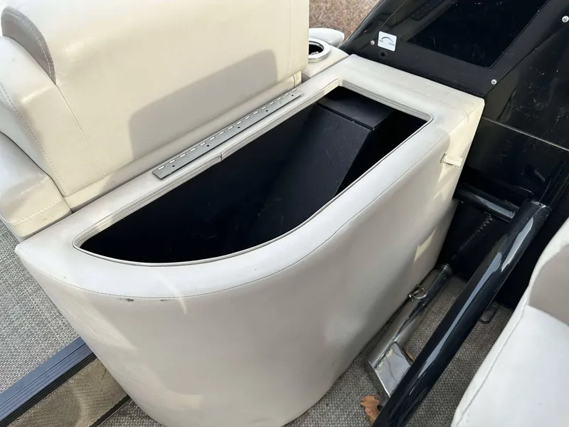Slide: The Image of 2016 Bennington 2875 QCW I/O boat storage compartment with beige upholstery. - 12