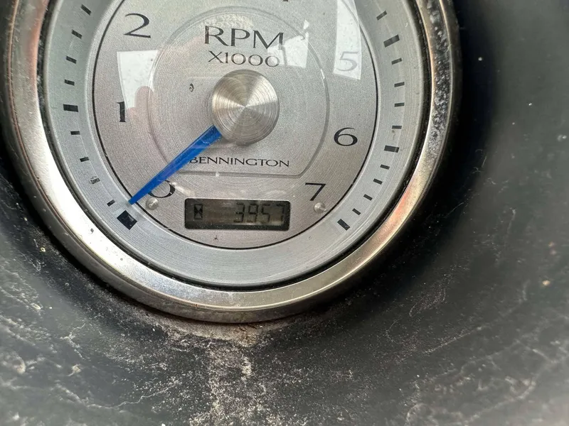 Slide: The Image of Close-up of a Bennington 2875 QCW I/O 2016 RPM gauge showing 395 hours. - 13