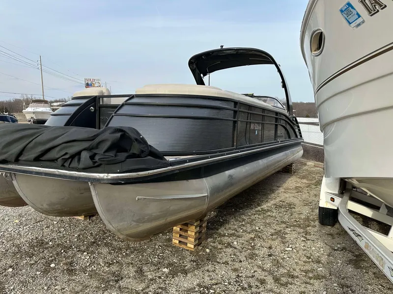 Slide: The Image of 2016 Bennington 2875 QCW I/O pontoon boat on dry land, side view. - 17