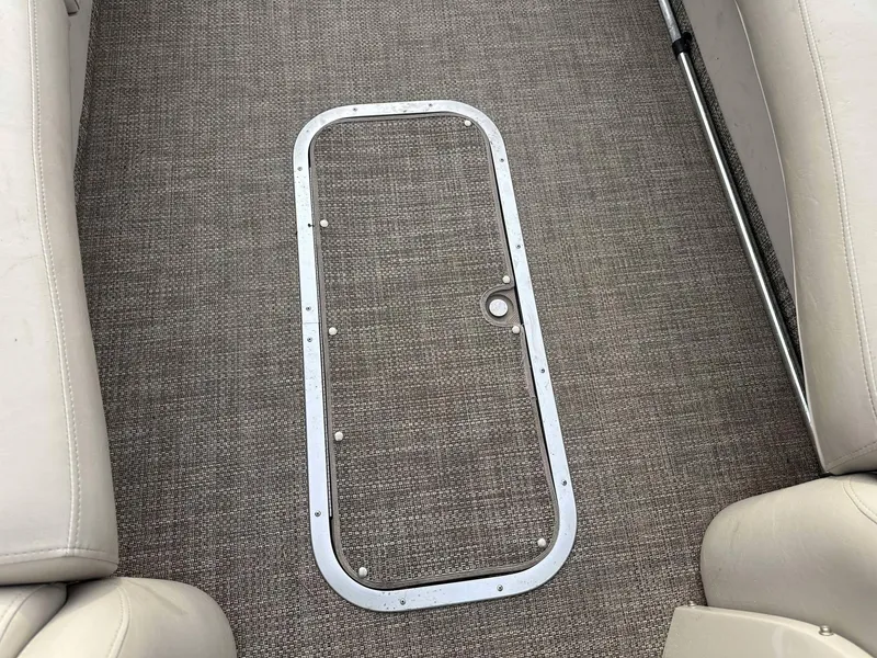 Slide: The Image of 2016 Bennington 2875 QCW I/O boat interior with carpeted floor and seating. - 18