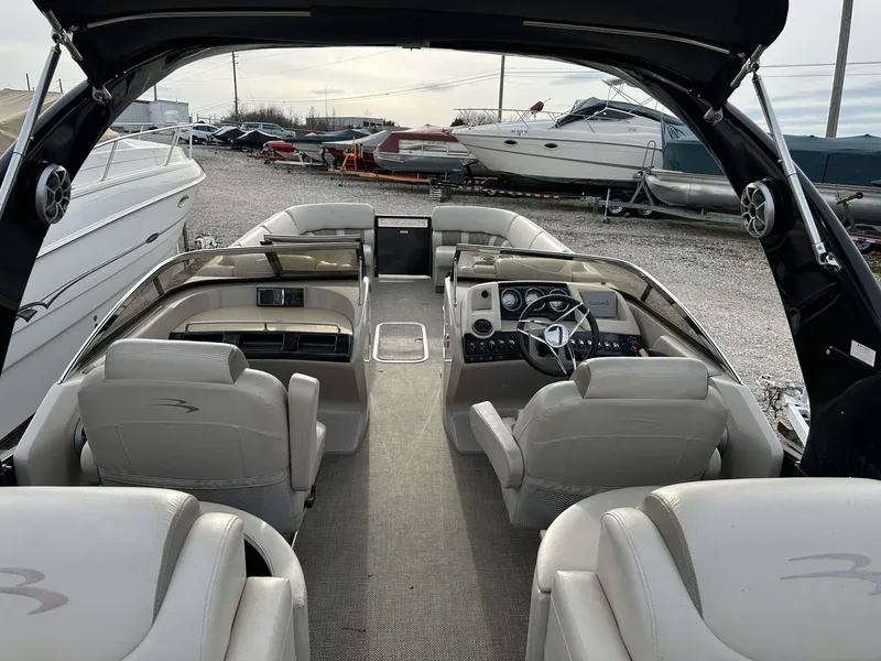 Slide: The Image of 2016 Bennington 2875 QCW I/O boat interior with luxurious seating and modern dashboard. - 20