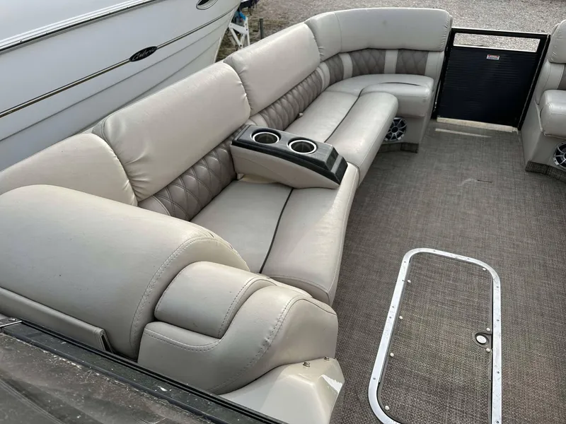 Slide: The Image of 2016 Bennington 2875 QCW I/O boat interior with plush seating and cup holders. - 24