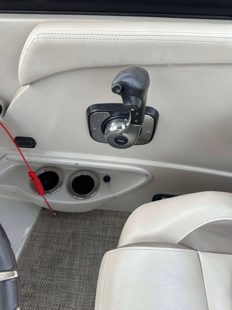 Slide: The Image of Interior of a 2016 Bennington 2875 QCW I/O boat showing throttle control and seating. - 26