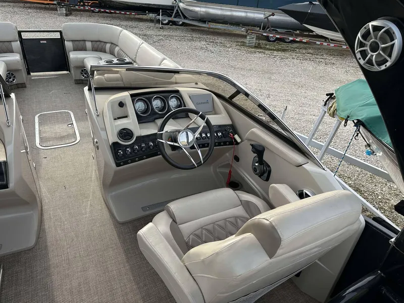 Slide: The Image of Interior of a 2016 Bennington 2875 QCW I/O boat with beige seating and steering console. - 27