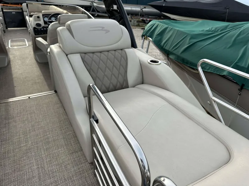 Slide: The Image of 2016 Bennington 2875 QCW I/O boat interior with luxurious seating and sleek design. - 28