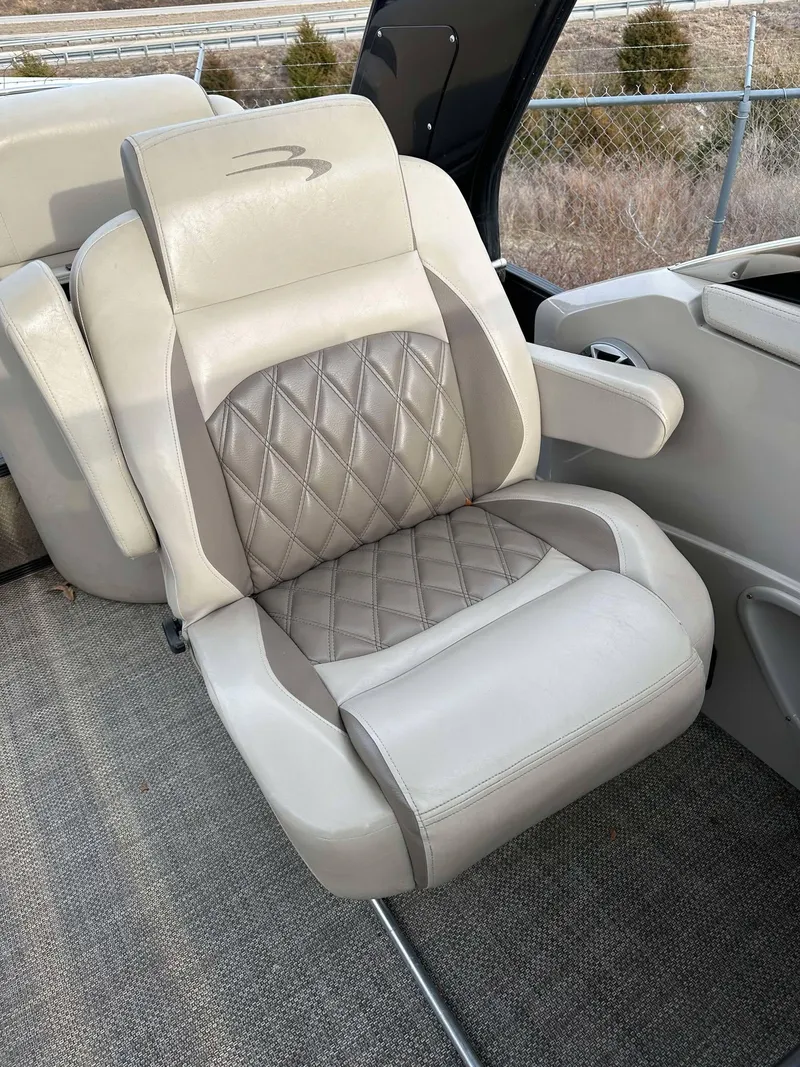 Slide: The Image of Luxury seating on 2016 Bennington 2875 QCW I/O boat, featuring diamond-stitched upholstery. - 4