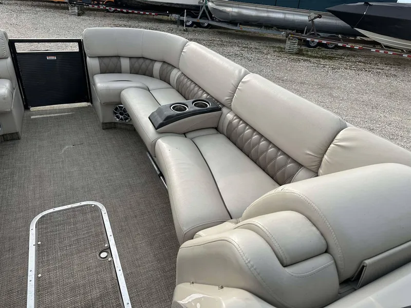 Slide: The Image of 2016 Bennington 2875 QCW I/O boat interior with plush seating and cup holders. - 6