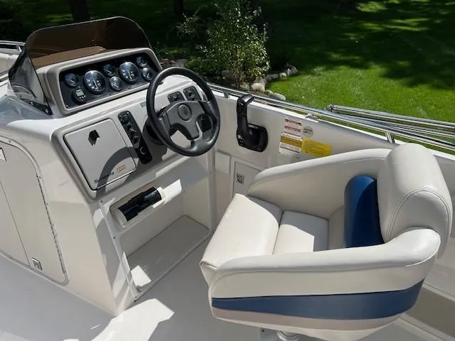Slide: The Image of 1995 Chaparral 220 Sunseta boat cockpit with steering wheel and control panel. - 3