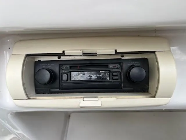 Slide: The Image of 1995 Chaparral 220 Sunseta boat stereo system with cassette player and volume controls. - 8