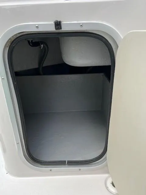 Slide: The Image of 1995 Chaparral 220 Sunseta storage compartment with open hatch, showcasing interior space. - 9