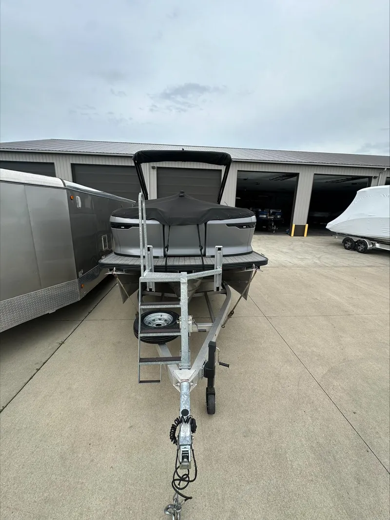 Slide: The Image of 2023 Manitou Explore boat on trailer in storage facility. - 5