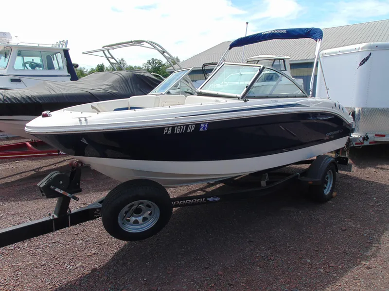 Slide: The Image of 2015 Chaparral 18 H2O Sport boat on trailer, blue and white exterior. - 1