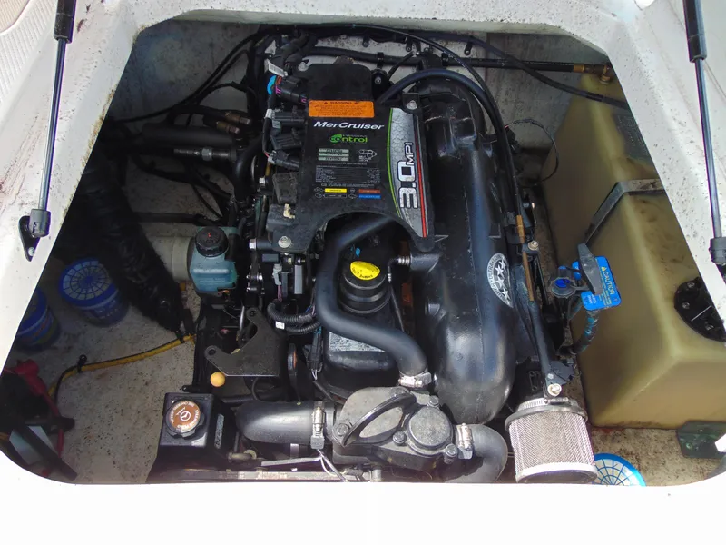 Slide: The Image of Engine compartment of a 2015 Chaparral 18 H2O Sport boat, featuring a MerCruiser engine. - 13